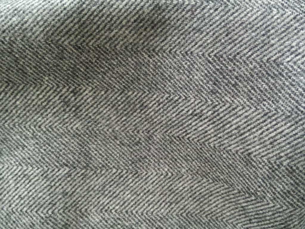 Swatches of various herringbone wool fabrics in different colors